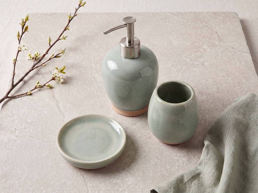 Celadon ceramic bathroom set seen from above, showing the round soap dish and open toothbrush holder