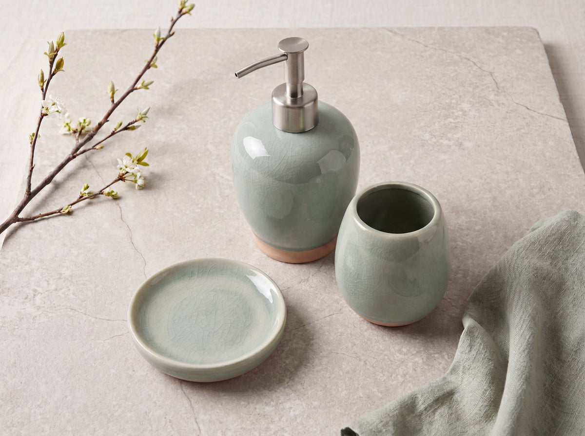 Celadon ceramic bathroom set seen from above, showing the round soap dish and open toothbrush holder