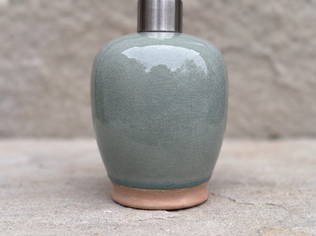 Close-up of the fine crackle in the celadon glaze above the unglazed terracotta foot