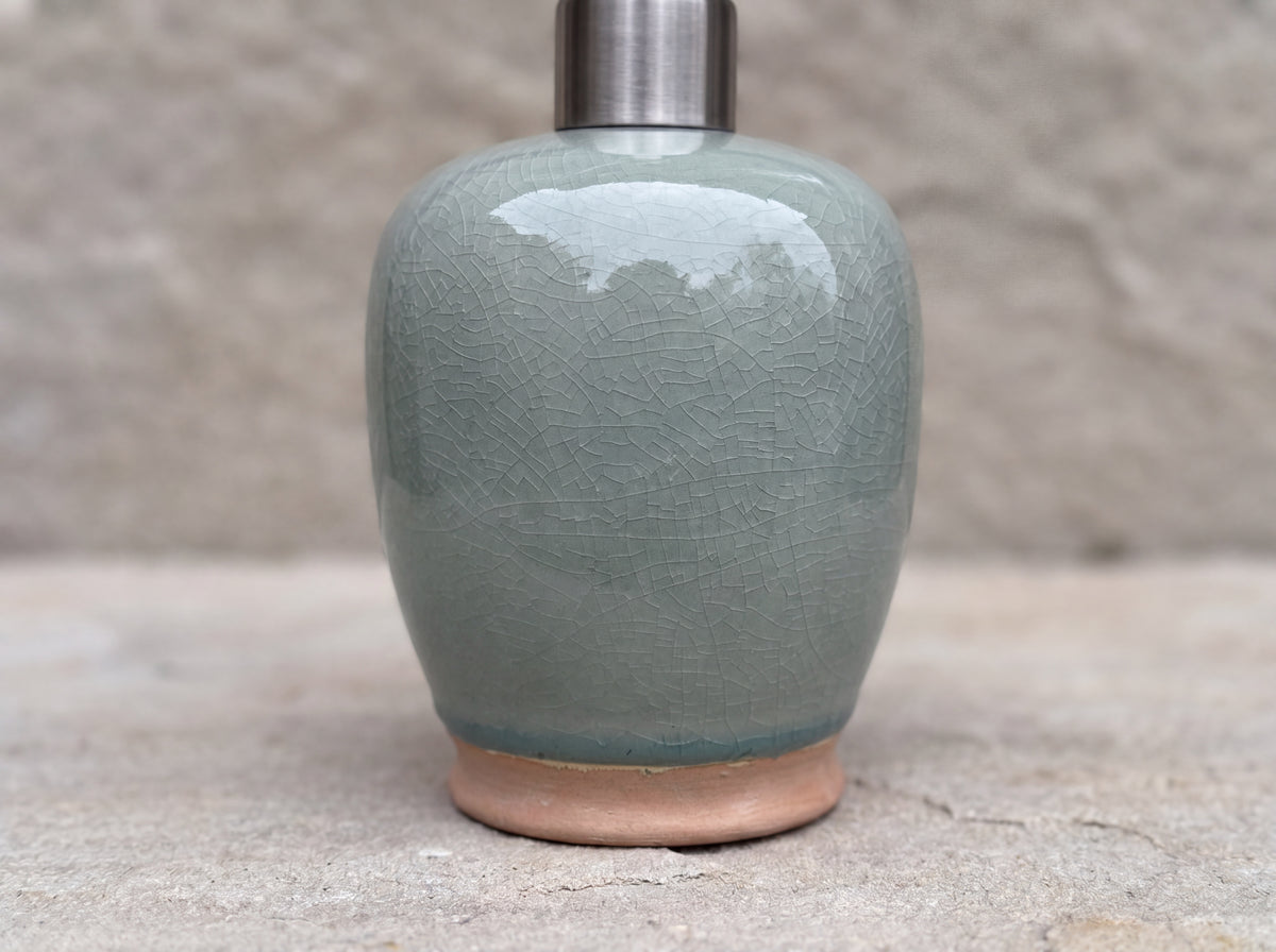 Close-up of the fine crackle in the celadon glaze above the unglazed terracotta foot