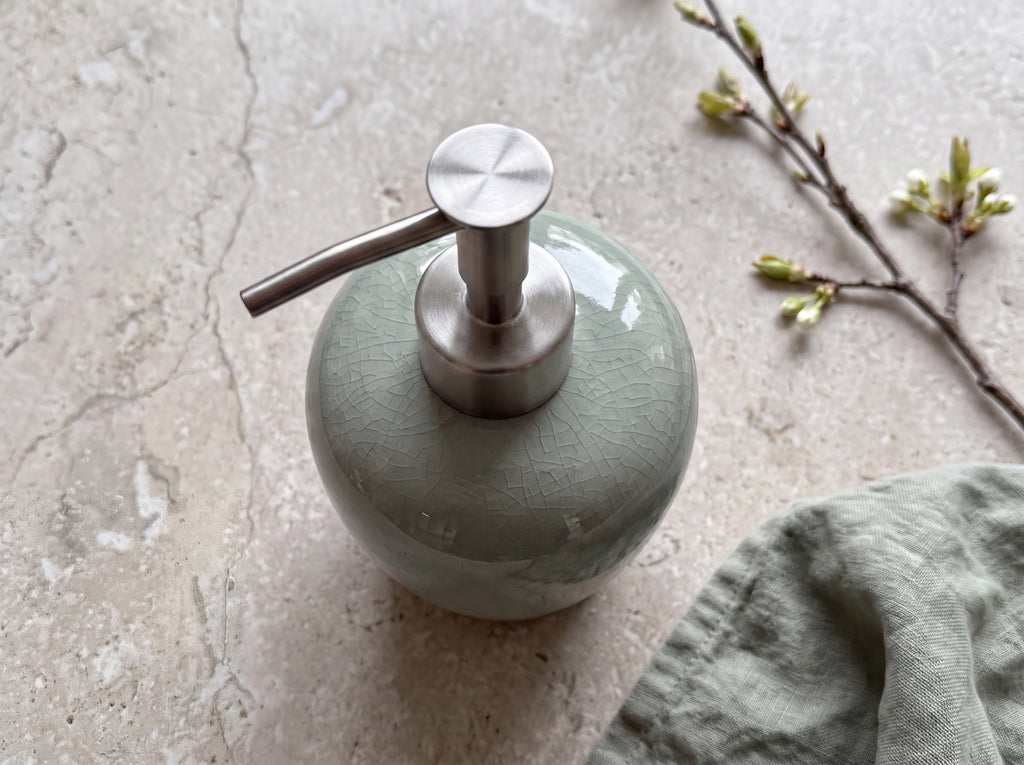 Brushed stainless steel pump on the celadon crackle-glaze ceramic dispenser