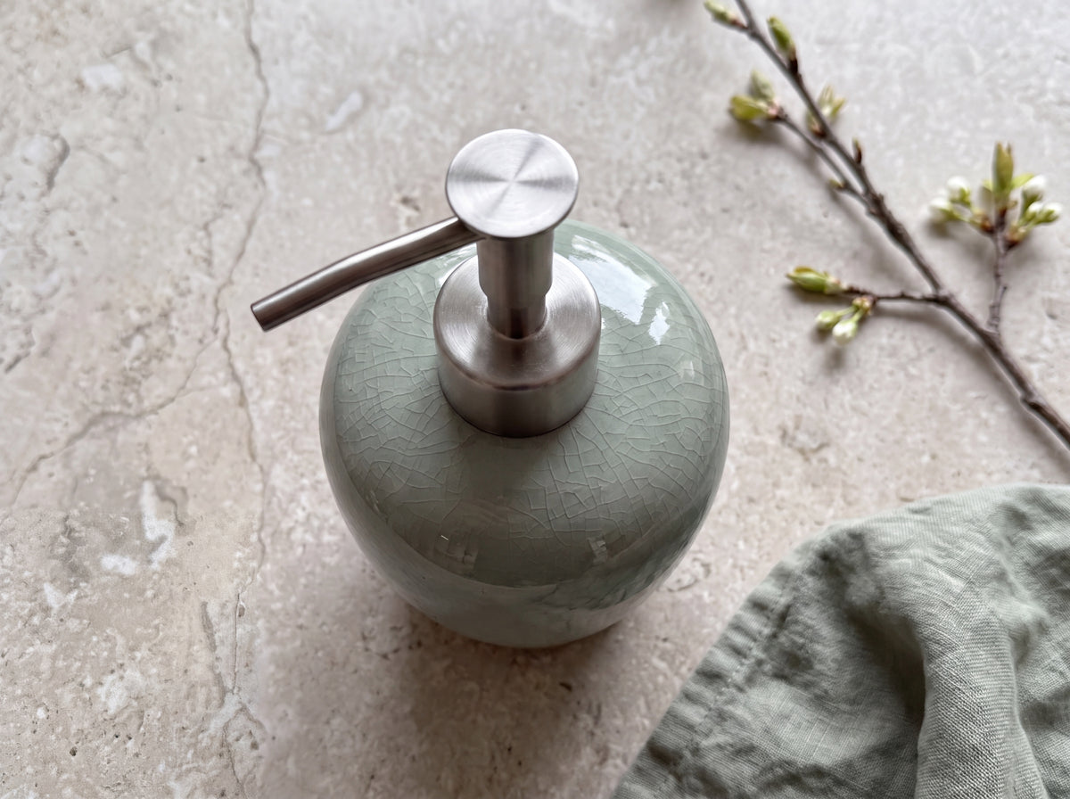 Brushed stainless steel pump on the celadon crackle-glaze ceramic dispenser