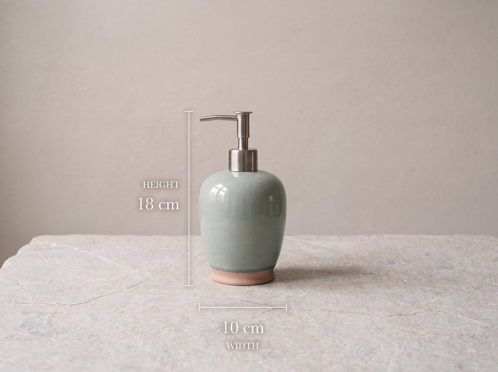 Celadon ceramic soap dispenser measuring 18 cm tall and 10 cm wide