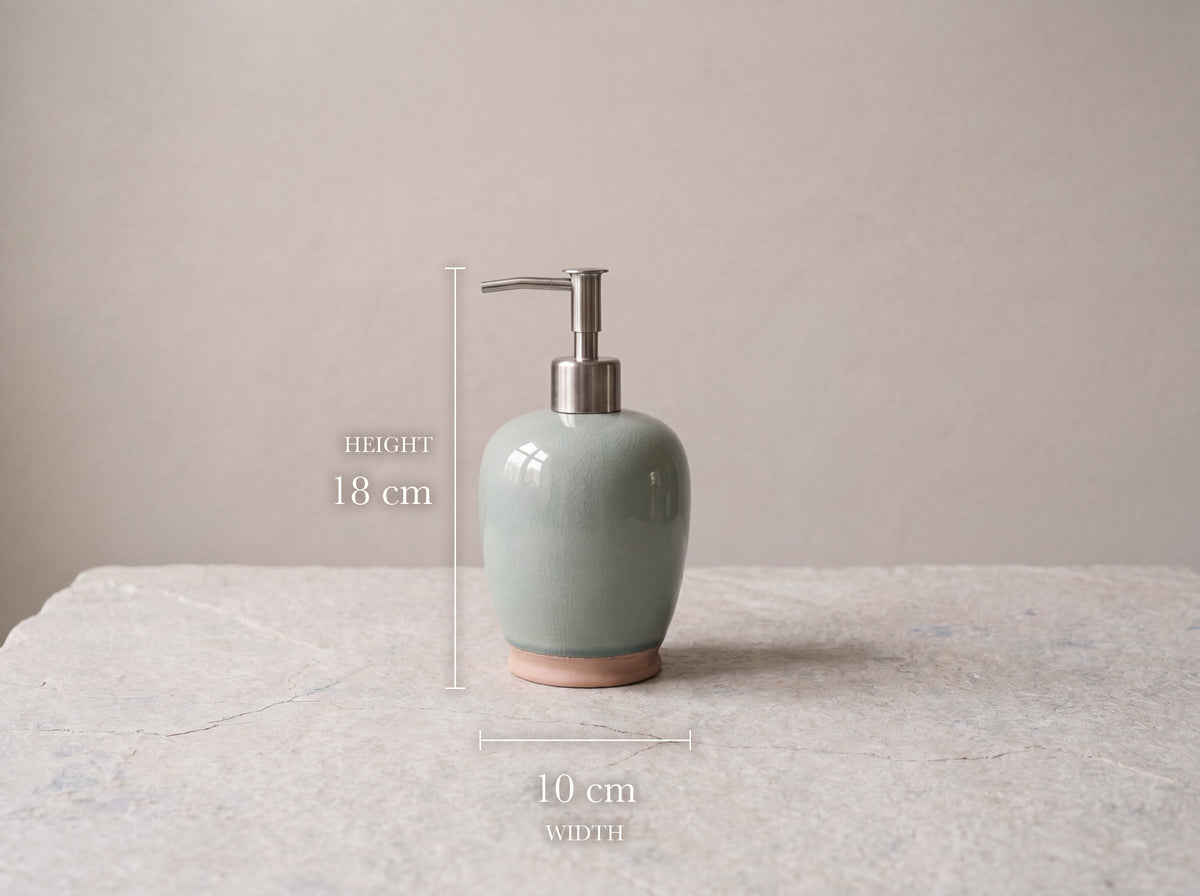 Celadon ceramic soap dispenser measuring 18 cm tall and 10 cm wide