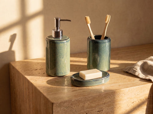 The blue-green set in daily use with toothbrushes in the holder and a soap bar on the dish.
