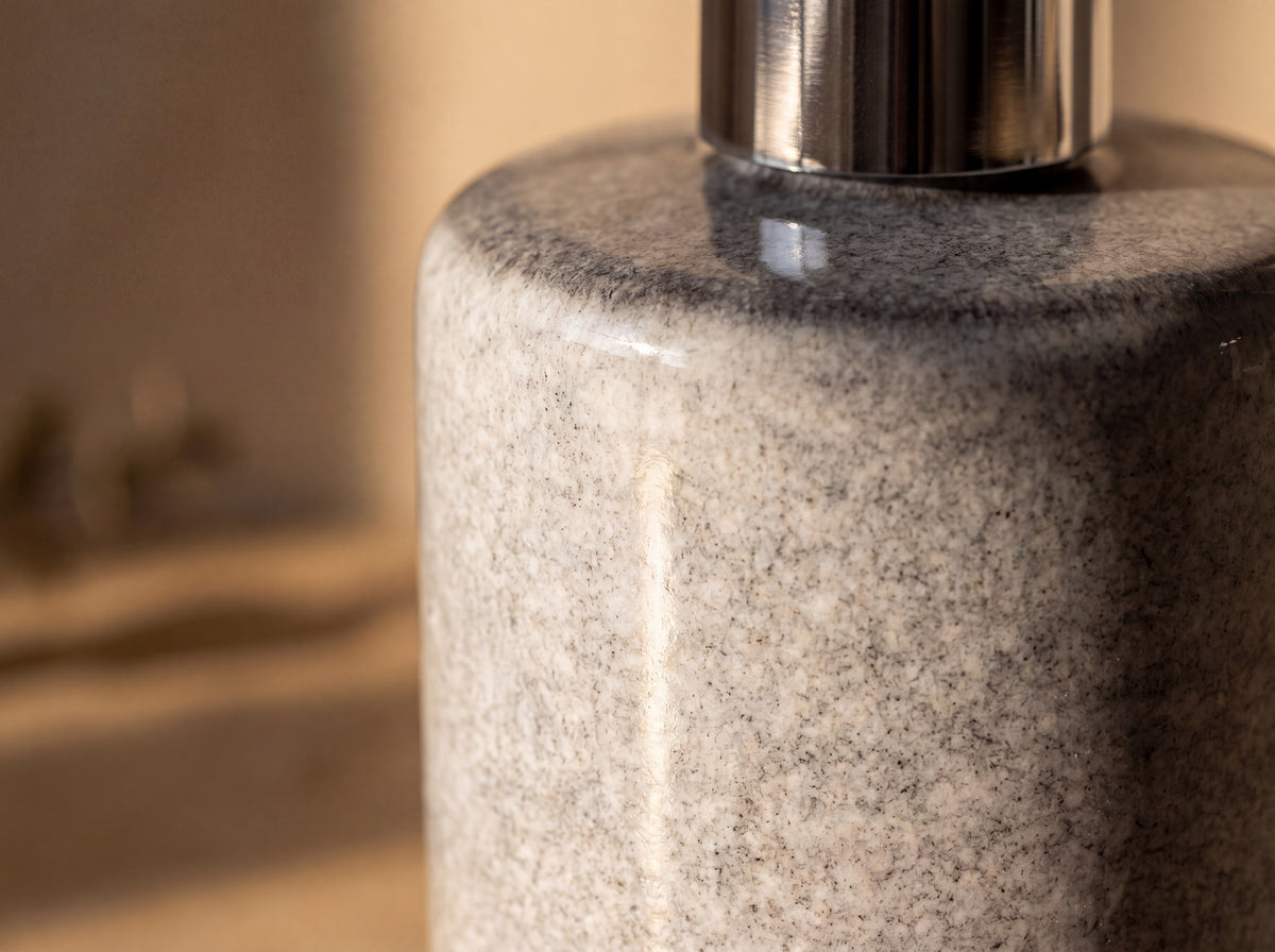Macro close up of the light heathered grey glaze with fine granite-like mottling and a soft gloss.