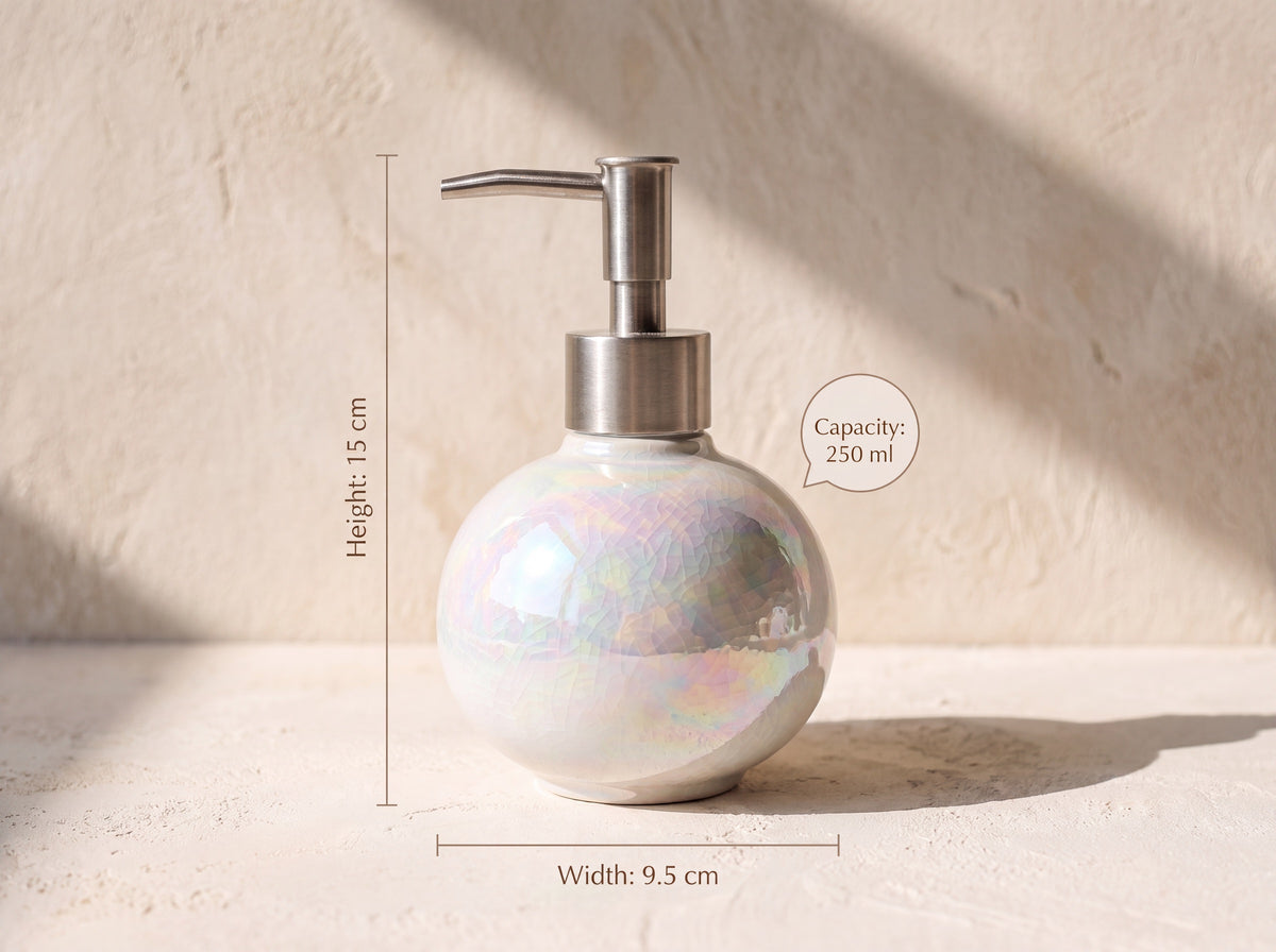 Round pearl ceramic soap dispenser with dimension labels: Height 15 cm, Width 9.5 cm, Capacity 250 ml, on a warm plaster backdrop.