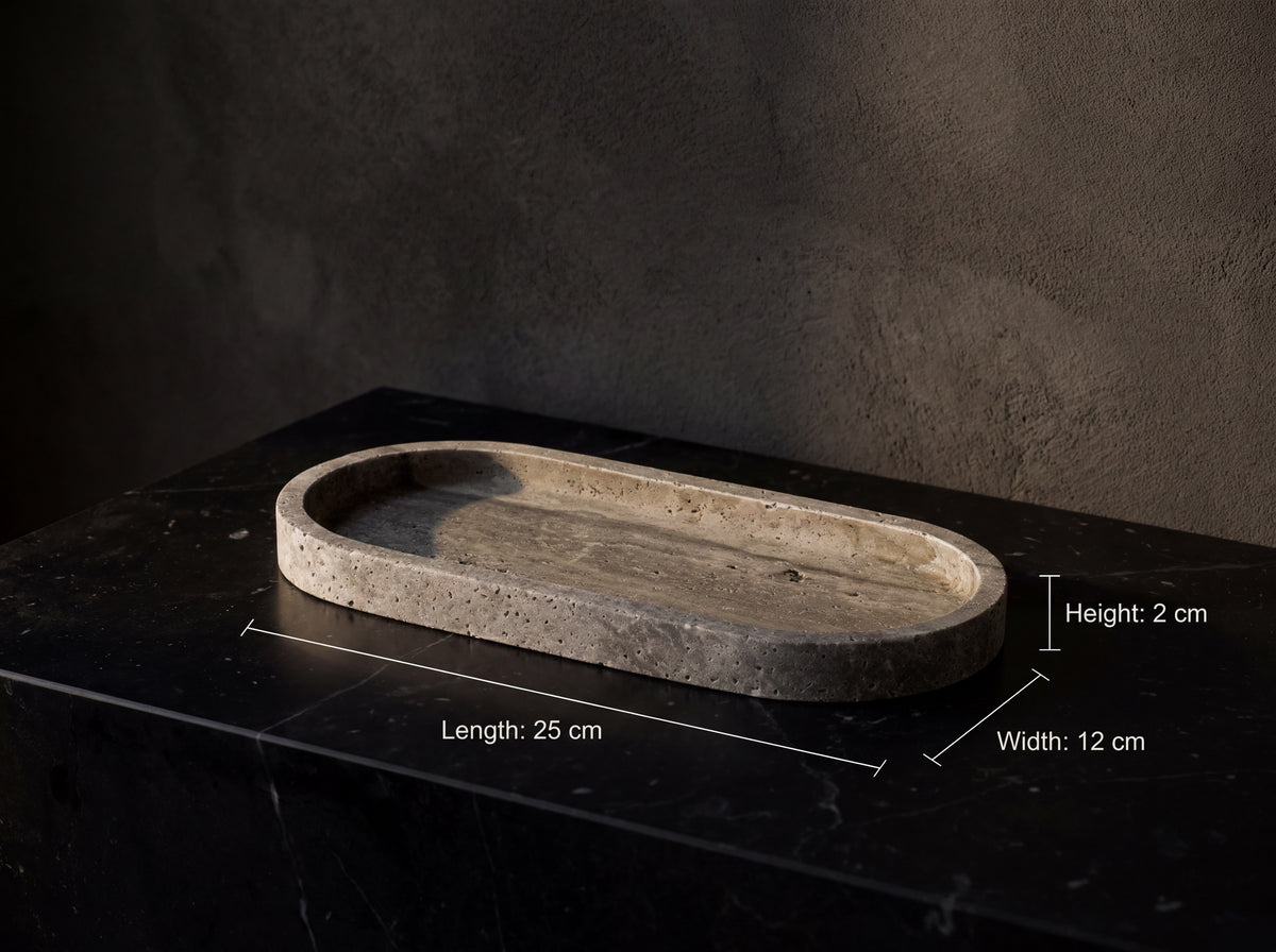 Oval gray travertine tray on a charcoal backdrop annotated with white serif labels: length 25 cm, width 12 cm, height 2 cm.