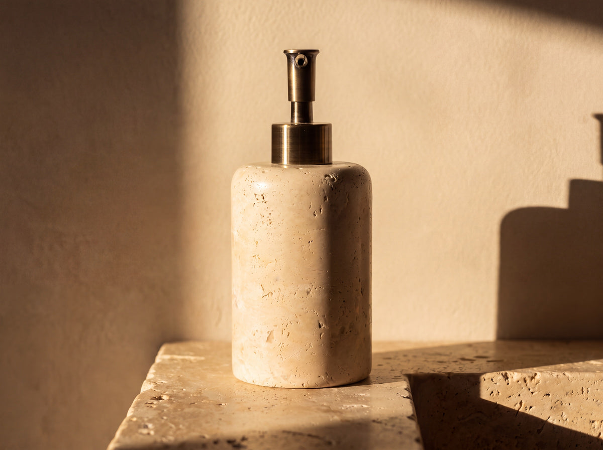 Back view of the travertine soap dispenser showing the unbroken sweep of natural stone pores and veining