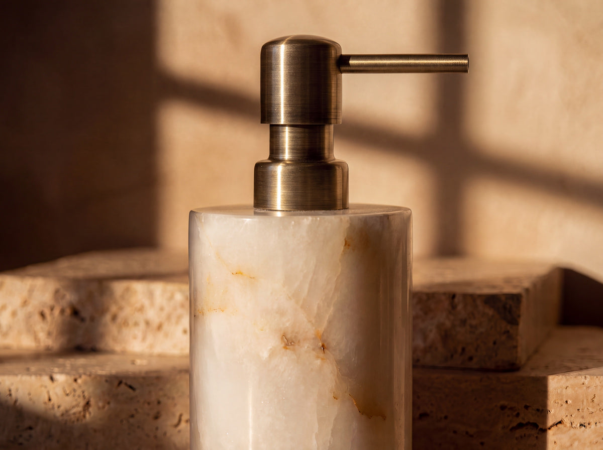 Close-up of translucent natural white jade veining on a soap dispenser with a brushed-gold pump.