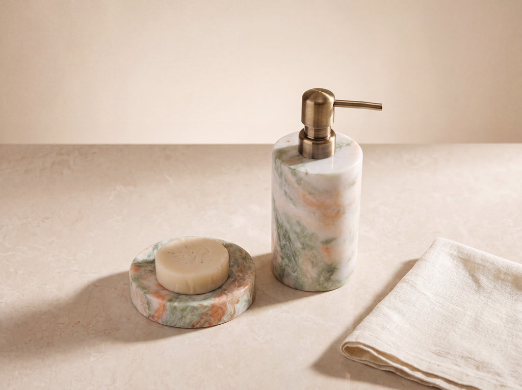 Marble soap dispenser and round soap dish side by side seen from a high angle