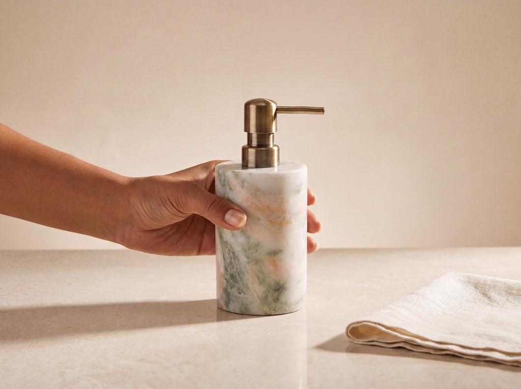 Marble soap dispenser held in a woman's hand to show its real size at 18 cm tall