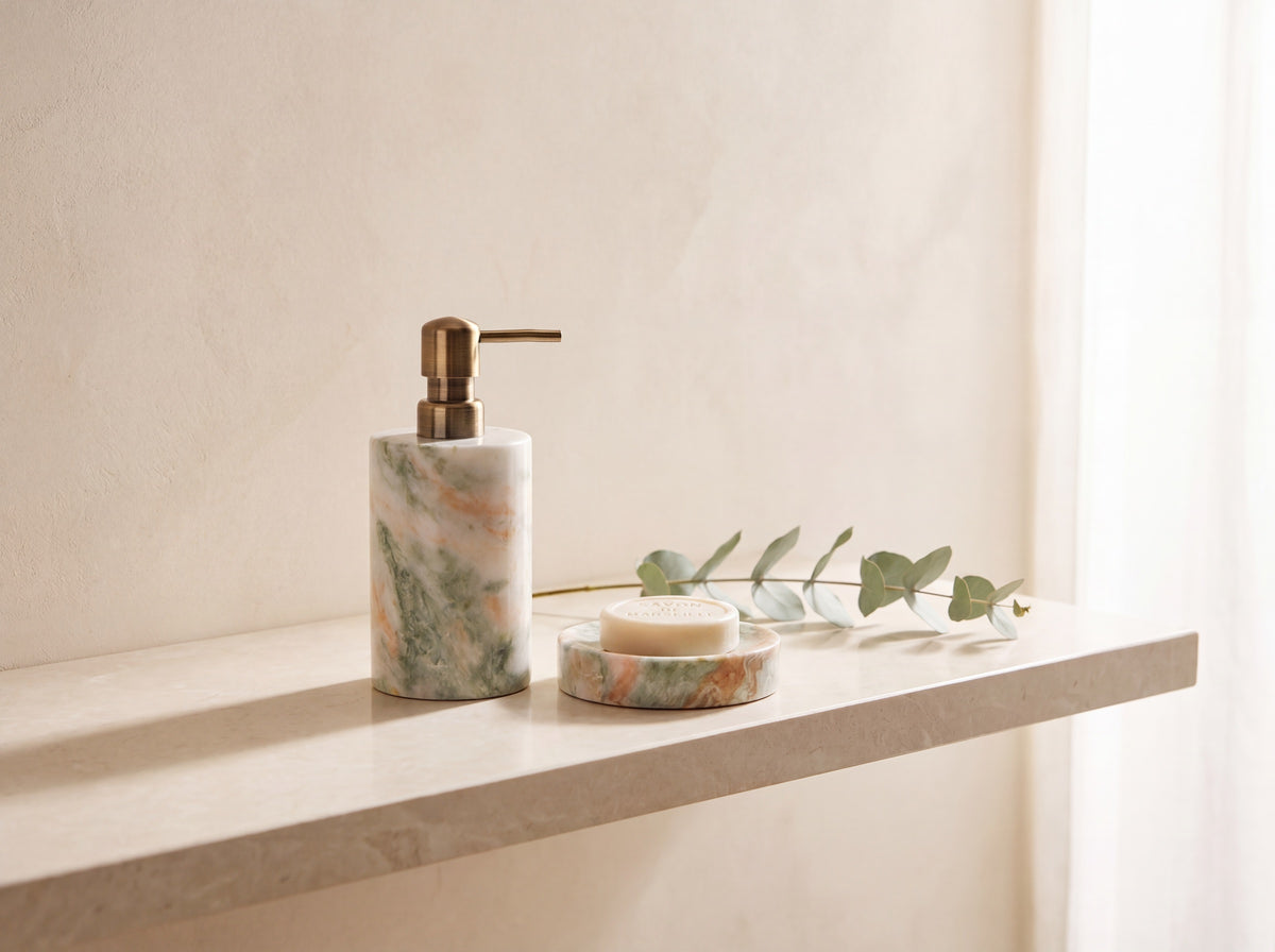 Marble soap dispenser and soap dish on a floating stone shelf with a eucalyptus stem